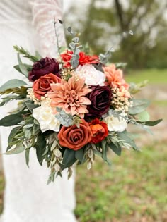 a bride holding a bouquet of flowers in her hands