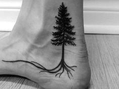 a foot with a tree on it that has roots growing out of the top of it