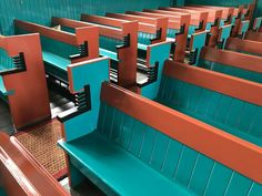 rows of blue and orange benches in a room