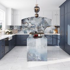 a large kitchen with marble counter tops and blue cabinetry, along with an island in the middle