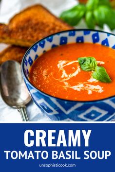 creamy tomato basil soup in a blue and white bowl