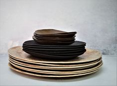 a stack of black plates sitting on top of each other