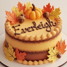 a cake decorated with fall leaves and acorns