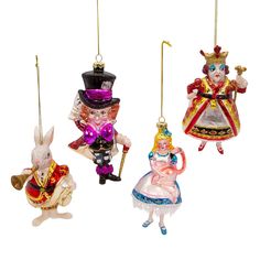 three glass ornaments in the shape of alice and wonderland characters hanging from strings on a white background