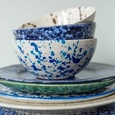 three blue and white bowls stacked on top of each other