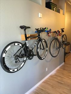 there are three bikes hanging on the wall next to each other in this bike rack