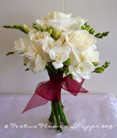 a vase filled with white flowers on top of a table