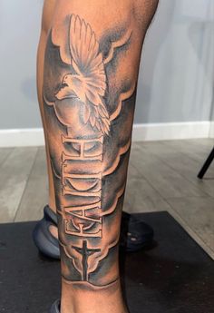 a man's leg with a bird on it and the word faith written in black ink