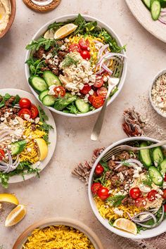 three bowls filled with different types of salads on top of a white tablecloth