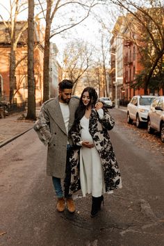 a man and woman are walking down the street