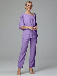 a woman wearing purple pants and a top