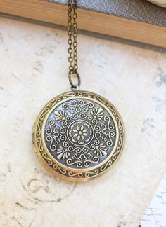 Large Round Locket Necklace Gold Floral by apocketofposies on Etsy Vintage Circle Necklace For Gifting, Vintage Circle Necklace For Gifts, Ornate Coin Pendant Necklace As Gift, Antique Gold Engraved Medallion Necklace, Engraved Antique Gold Medallion Necklace, Antique Medallion Necklace With Locket For Gift, Antique Medallion Locket Necklace As Gift, Brass Medallion Locket Necklace, Antique Gold Round Pendant Locket Necklace