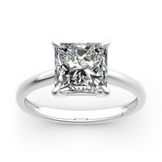 a princess cut diamond engagement ring on a white background, with the center stone visible