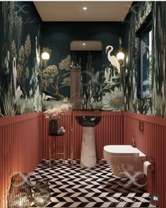 the bathroom is decorated in black and white checkered flooring, with flamingos on the wall