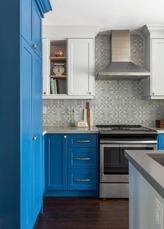 a kitchen with blue cabinets and white cupboards