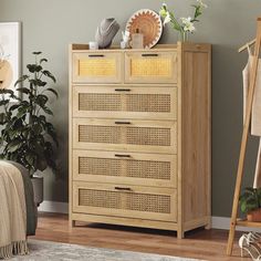 a wooden cabinet with baskets on top of it in a living room next to a bed