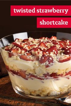 a strawberry shortcake in a glass dish on top of a wooden table with the words twisted strawberry shortcake above it