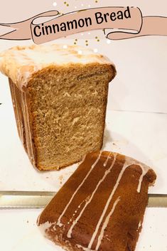 a loaf of cinnamon bread sitting on top of a counter next to a slice of cake