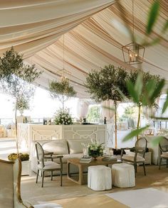 the inside of a tent with tables and chairs