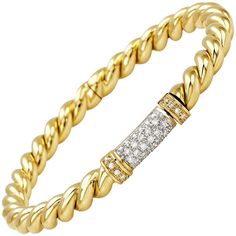 Embrace the timeless elegance of the Rope Bangle from the traditional Micheletto collection, meticulously crafted in luxurious 18 karat yellow gold and adorned with sparkling white diamonds. This exquisite piece combines classic design with sophistication, making it a versatile addition to any jewelry collection. Features: Material: 18 Karat Yellow Gold Total Gold Weight: 21 grams Diamond Details: 0.55 carats total weight, GH color, VVS1 clarity Design: Rope motif with inset white diamonds Stamp