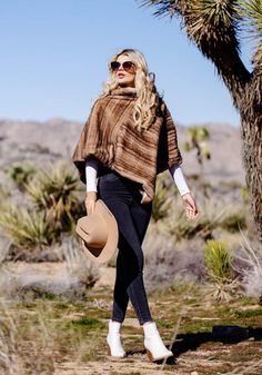 The Classic Mink Poncho is feel-good fashion--effortlessly chic, cool and confident! Super-soft and substantial, the Toffee fur is a variegated blend of Tawny Tans, on a textural grid of narrow pelt lines. Artfully placed, pelt lines ensure a sleek, fluid, and flattering look. Designed to slip easily over the head, a face-framing cowl neck collar gives the Classic Mink Poncho a strong shoulder line. Measuring a generous 29" at center back, this one-size-fits-most poncho has a cozy velvet lining. Where Winters are mild, the Classic Mink Poncho may be the only wrap you'll need. Easy to care for as well, the Classic has the added convenience of machine wash/dry flat. Fall Faux Fur Cape, Women's Ponchos & Wraps, Kids Vest, Fabulous Furs, Strong Shoulders, Ladies Poncho, Fake Fur, Kids Coats, Women's Coats & Jackets