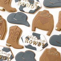 some cookies that are shaped like cowboy boots and boots with the words cowboys row on them