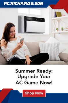 a woman is sitting on the couch and looking at her cell phone while she reads, summer ready upgrade your ac game now