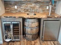 a kitchen with a sink, refrigerator and wine barrel