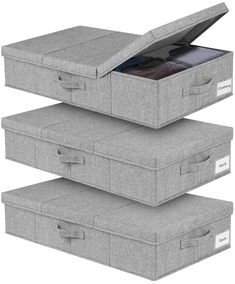 three grey storage boxes stacked on top of each other with clothes in the bottom drawer