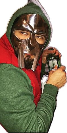 a man wearing a mask and holding a cell phone