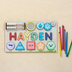 an assortment of colored pencils, markers and magnets on a white surface with the words hayden written in it