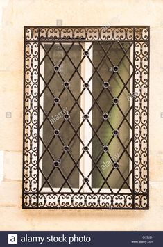 an iron window on the side of a building