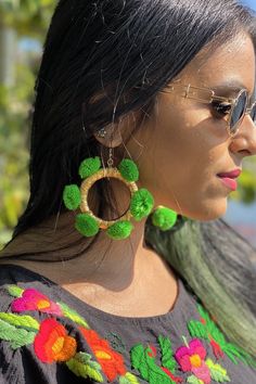 Alexia Hoops - Golden Green The most fun earrings to compliment any outfit. Very light weight, hypoallergenic and nickel free!! Our newest additions, designed by yours truly, we know you'll enjoy them and guarantee they will get you compliments left and right from both men and women. Grab a pair and instantly feel playful! Designed by Us, Fair Trade made in India by artisans. MEASUREMENTS: CIRCUMFERENCE: 3" Pom Pom Earrings, Golden Green, Green Earrings, Yours Truly, Boho Vibe, Fun Earrings, Gold Hoop, Embroidered Top, Bright Green