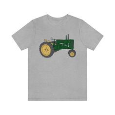 "I grew up going to John Deere tractor shows with my family. I was more excited about selling Lemonade at the shows when I was a kid, but John Deere's do hold a special part in my heart :D This is a great shirt for anyone that knows \"Nothing Runs like a Deere!\"  We also have a John Deere Style tractor Model D shirt in our store! This classic unisex jersey short sleeve tee fits like a well-loved favorite. .: 100% Airlume combed and ringspun cotton (fiber content may vary for different colors) . We Ride At Dawn, Tee Shorts, Happy Hippie, Custom Drawing, Hand Drawn Design, Branded Shirts, Unisex Tshirt, Comfy Fits, John Deere