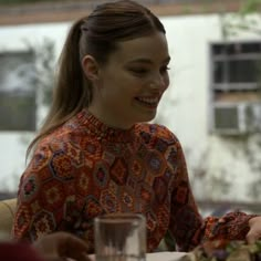 a woman sitting at a table with food in front of her