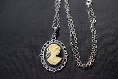 Vintage Lace Cameo Necklace - Cameo Pendant - Antique Silver Brass - Cameo Lover Gift . . . This reproduction beautiful ivory and black cameo necklace features a Victorian woman cameo hand in a vintage lace style bezel. is made of alloy metal with a matte antique silver brass finish. The cameo pendant suspends from high quality hypoallergenic soldered flat cable matte not shiny antique silver electroplated chain, and fastens with antique silver plated lobster claw. Perfect Downton Abbey or Neocl Victorian Cameo Jewelry For Party, Vintage Cameo Jewelry For Party, Elegant Cameo Necklace For Vintage Events, Silver Cameo Jewelry For Party, Party Silver Cameo Jewelry, Black Cameo, Vintage Cameo, Victorian Women, Cameo Necklace