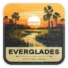 the evergladess national park sign with palm trees and water in the background