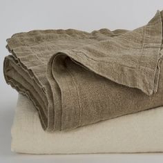 two folded linens sitting on top of each other