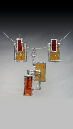 three pieces of glass hanging from a string