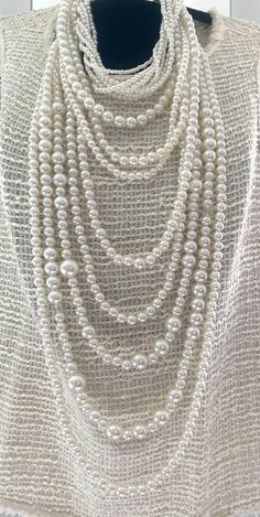 Stunning long multi-strand statement pearl necklace. Featuring a trendy layered chunky choker design. This cascade necklace showcases a beautiful waterfall of faux pearls in varying sizes, from delicate 2mm to bold 20mm. Perfect for adding a touch of elegance to any outfit, it's the ideal accessory for both casual and formal occasions. Make a statement with this eye-catching piece that effortlessly blends classic charm with modern flair. The necklace measures:  choker size 18" +4" (48 cm+10cm) Longest row : 46" (117 cm) Necklace drop: 23"(58cm) ----If you have any question please contact me---- I am inviting you to explore and enjoy my jewelry store; perhaps you will discover something unique for yourself or as a gift for someone special in your life. Thank you! https://www.etsy.com/shop/B Luxury Single Strand Long Beaded Necklace, Pearl Necklace Layered, Statement Pearl Necklace, Choker Design, Cascade Necklace, Chunky Choker, Choker Designs, Pearl Beaded Necklace, Pearl Statement Necklace