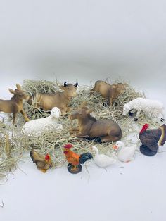 a pile of fake farm animals sitting on top of hay