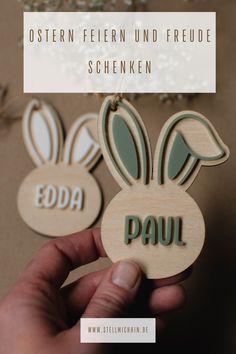 two wooden bunny ears with the word'edda'in german, and an image of