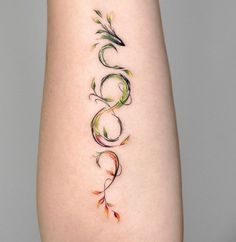 a woman's lower arm with an artistic tattoo design on the left side of her body