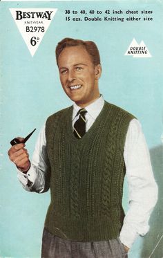 a man wearing a sweater vest and tie holding a pipe in one hand while smiling at the camera