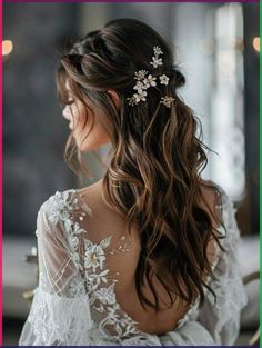 the back of a woman's head with long hair and flowers in her hair