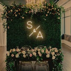 a sign that says s & a with flowers on it