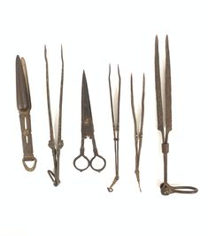 an assortment of old scissors and shears on a white background