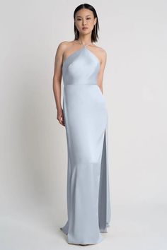 a woman in a white gown with an asymmetrical slit on the side