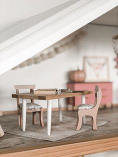 a doll house with furniture and accessories on the floor in front of a staircase case