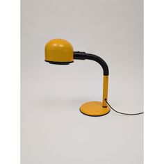 a yellow and black desk lamp on a white background